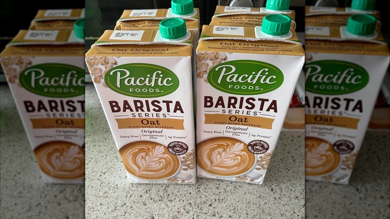 Mirrored image of cartons of Pacific Foods Barista Oat Milk on kitchen worktop