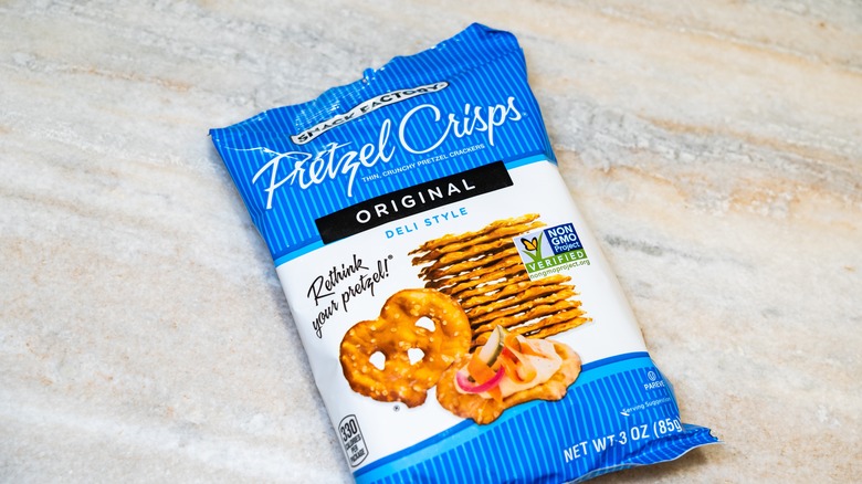 A bag of Snack Factory Pretzel Crisps Original Deli Style on marble background