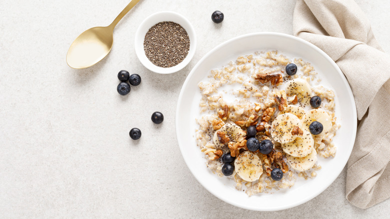 Massive bowl of oatmeal topped with nuts and fruit