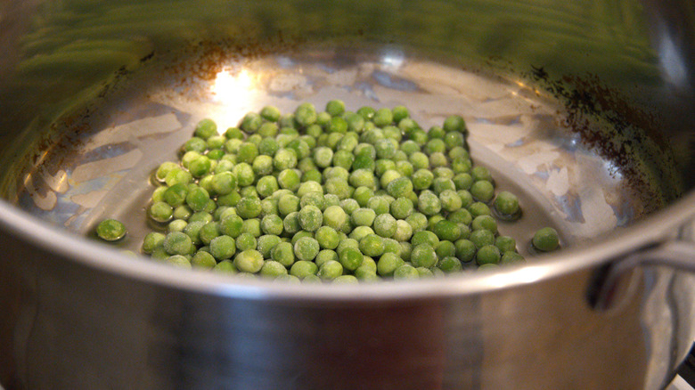 Close up of frozen peas in a pan