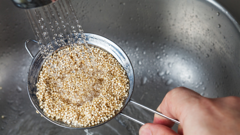 Person rinsing quinoa in the sink
