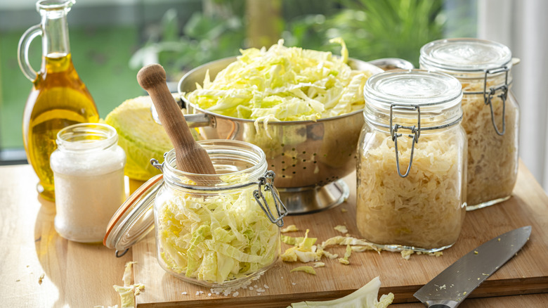 Elements of homemade sauerkraut assembled on a wooden board
