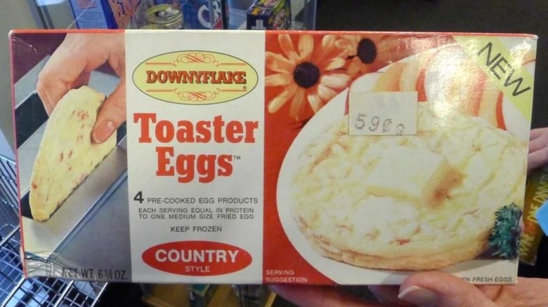 A hand holds a box of Toaster Eggs.