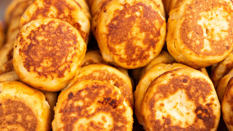 Pile of crispy cheese-filled arepas