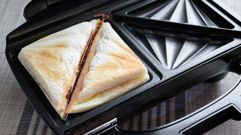 Cheese toastie cooking in sandwich toaster
