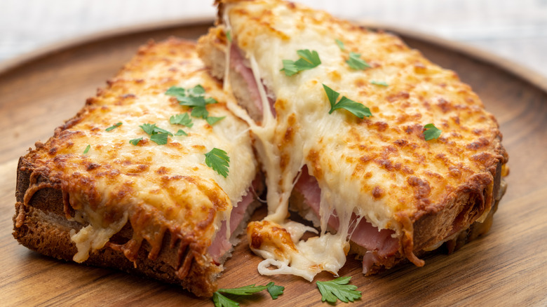 Croque monsieur cheese and ham sandwich garnished with fresh parsley