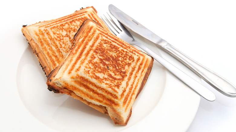 Australian jaffle grilled sandwiches on white plate