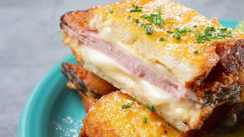Close up of Monte Cristo sandwich on plate, dusted with powdered sugar