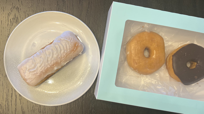 White iced cream-filled Long John from Kroger on a plate
