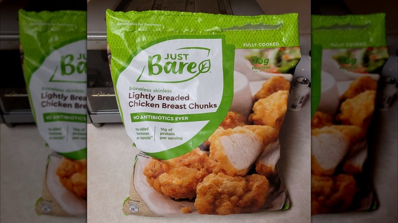 A package of Just Bare Lightly Breaded Chicken Breast Chunks from Costco in front of an air fryer