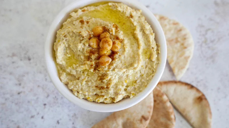 Instant Pot Hummus in white bowl with pita