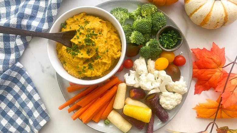 Roasted Garlic Pumpkin Hummus on plate with fresh vegetables