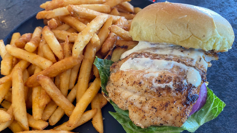 Blackened grouper sandwich with side of french fries
