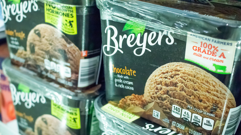Several cartons of Breyers ice cream in a freezer