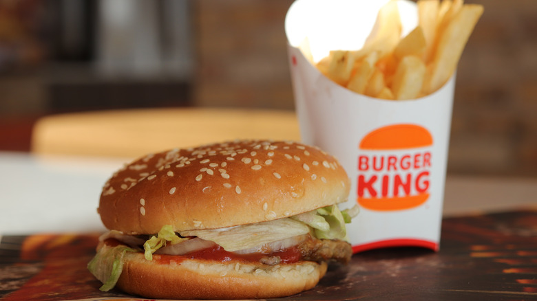 Whopper on a table with fries