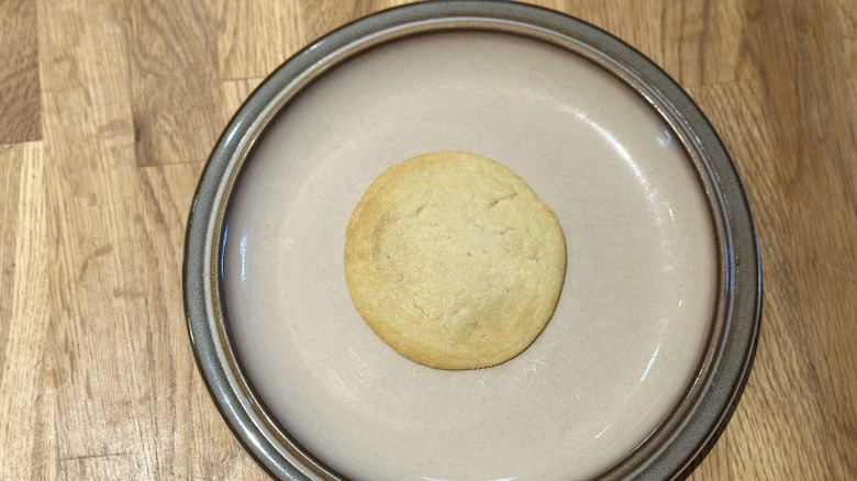 Overhead image of sugar cookie on a plate on a wooden counter
