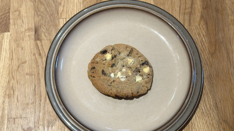 Overhead image of cookie and cream cookie on a plate on a wooden counter