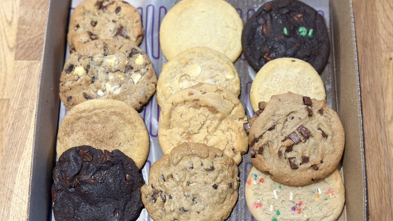 Overhead image of box of 12 cookies from Insomnia Cookies on a wooden counter