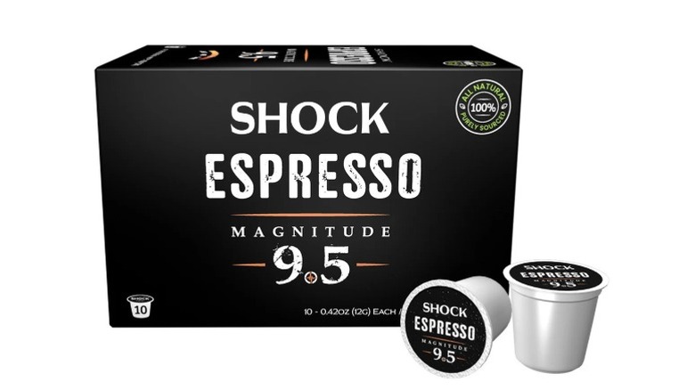 A box and a couple of Shock Coffee Espresso 9.5 Magnitude K-cup pods on a white background