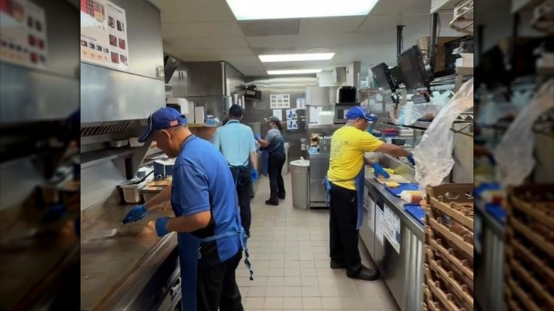 Culver's customer holding up a delicious and fresh ButterBurger