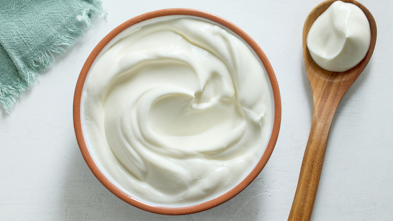 Sour cream in bowl with spoon