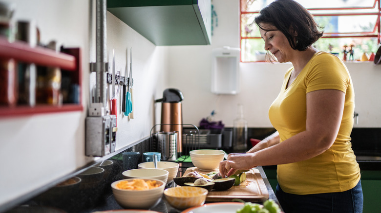 A woman preparing food in a home kitchen