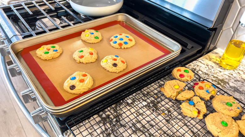 Candy cookies on silicone baking mat on metal cookie sheet