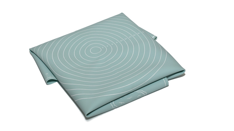 Folded silicone baking mat on white background