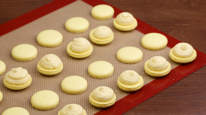 Cookies on baking mat on wooden table