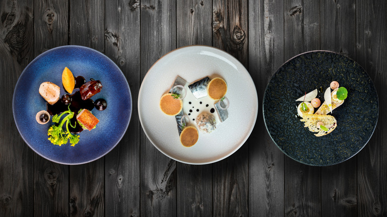 Three haute cuisine dishes on table