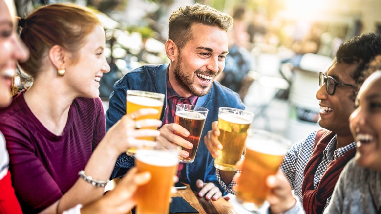people laughing with beer glasses