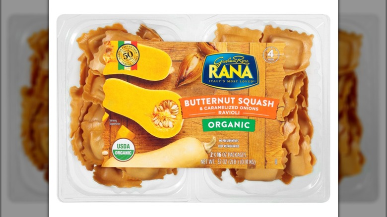 Overhead shot of plastic package of ravioli with images of butternut squash on label