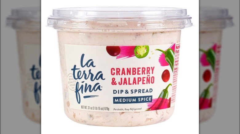 Plastic tub of La Terra Fine cranberry and jalapeño dip and spread with images of cranberries and jalapeños on label