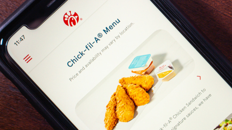 Smartphone screen showing Chick-fil-A's mobile menu with crispy chicken tenders and dipping sauces