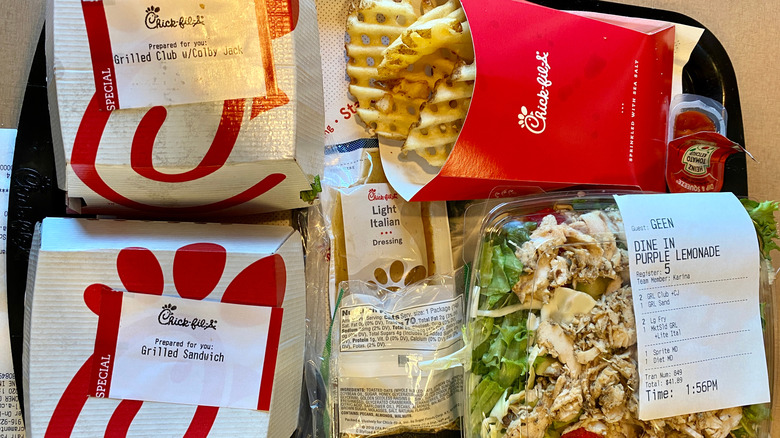 Two Chick-fil-A chicken sandwiches, waffles fries, and salad on a tray