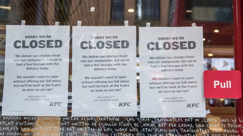 Close up of KFC door with three closure notices