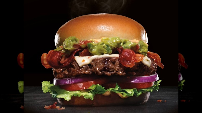 Carl's Jr. Guacamole Bacon Burger against dark background