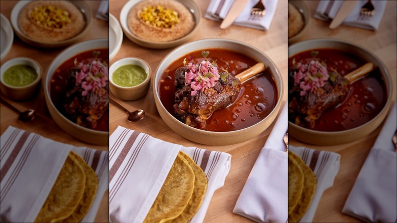 Meat, tortilla, salsa, and other dishes on a table at Alma Fonda Finda