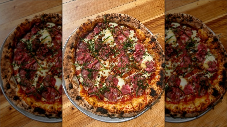 Wagyu striploin pizza from Staplehouse on a wooden table