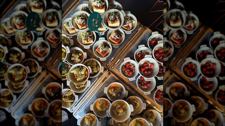 Four types of dishes stacked onto trays at State Bird Provisions