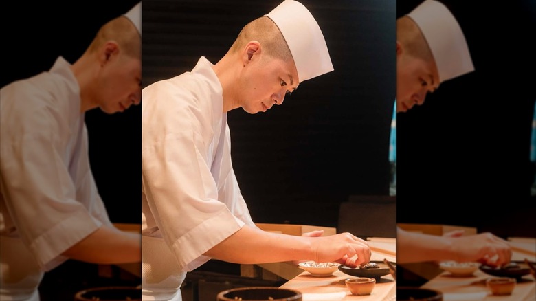 Chef preparing a course at Sushi Sho in Hawaii