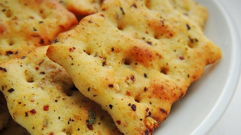 Close-up of seasoned fire crackers on a white plate.
