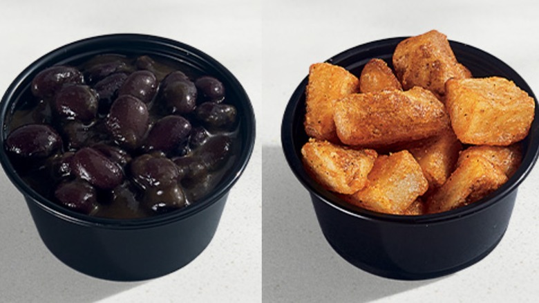 Black container of black beans and black container of potatoes