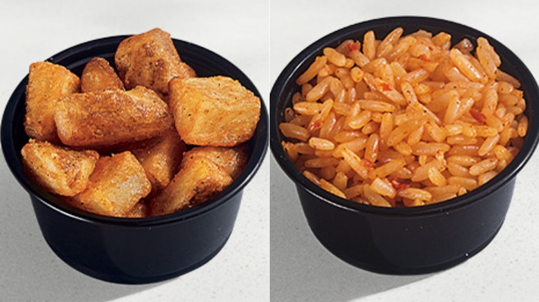 A black container of potatoes next to a black container of rice