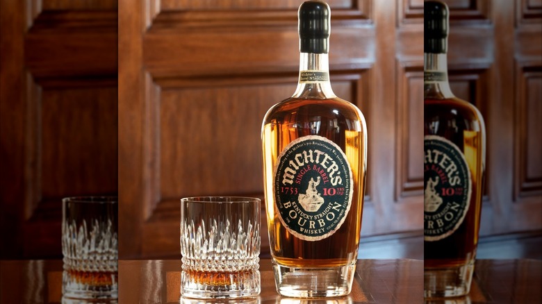 Bottle of Michter's 10 Year Single Barrel Bourbon with glass on table