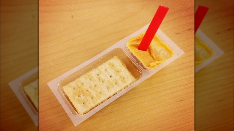 An open Kraft Handi-Snacks package with the plastic red stick