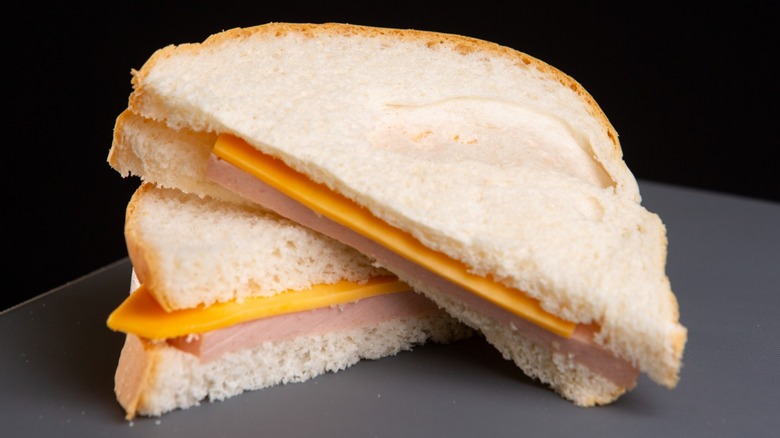 A bologna and cheese sandwich on white bread