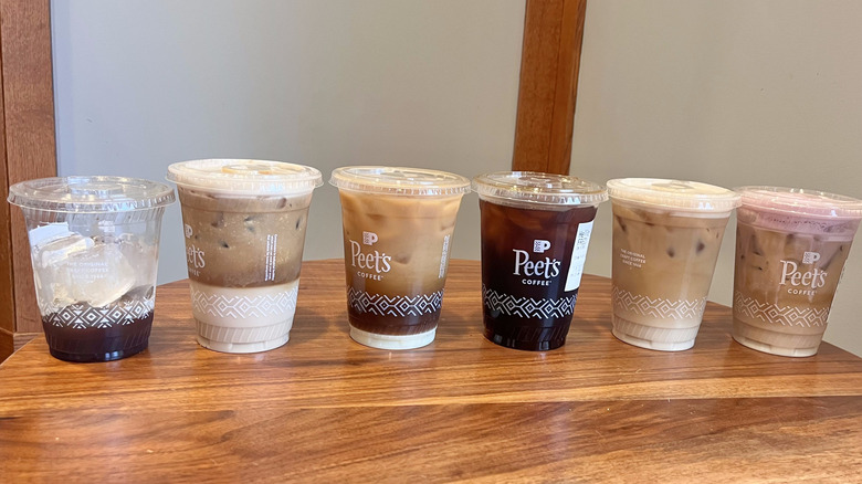 Six iced coffee drinks on a table