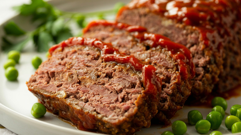 Sliced meatloaf on a plate with ketchup glaze