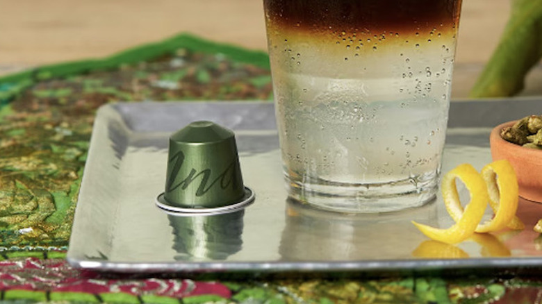 An India single origins Nespresso pod on a silver tray